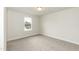 Well-lit bedroom features a window and neutral carpet at 410 Hopewell Branch Ct, Smithfield, NC 27577