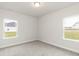 Bright, neutral bedroom with dual windows and soft carpeting at 410 Hopewell Branch Ct, Smithfield, NC 27577