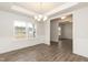 Elegant dining room with wainscoting, chandelier, wood floors, and abundant natural light at 410 Hopewell Branch Ct, Smithfield, NC 27577