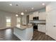 Well-lit kitchen with a large island, stainless steel appliances, and granite countertops at 410 Hopewell Branch Ct, Smithfield, NC 27577