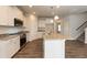 Modern kitchen with granite countertops, stainless steel appliances, and a large island at 410 Hopewell Branch Ct, Smithfield, NC 27577