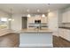 Modern kitchen features a large island, granite countertops, and stainless steel appliances at 410 Hopewell Branch Ct, Smithfield, NC 27577
