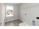 Bright laundry room with tile floors, window, and washer and dryer hookups at 410 Hopewell Branch Ct, Smithfield, NC 27577