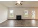 Bright living room featuring a fireplace, hardwood floors, and natural light at 410 Hopewell Branch Ct, Smithfield, NC 27577