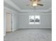 Main bedroom with light gray carpet, ceiling fan, and tray ceiling at 410 Hopewell Branch Ct, Smithfield, NC 27577