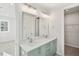 Bathroom with a double sink vanity, blue cabinets, and a mirror at 4511 Mint Leaf Ln, Raleigh, NC 27612