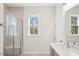 Bathroom with a shower and glass doors, offering natural light from a window at 4511 Mint Leaf Ln, Raleigh, NC 27612