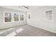 Bright bedroom featuring three large windows and a ceiling fan at 4511 Mint Leaf Ln, Raleigh, NC 27612