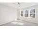 Bright bedroom with three large windows and a ceiling fan at 4511 Mint Leaf Ln, Raleigh, NC 27612