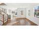 Open concept living space featuring hardwood floors, stairs, and a view of the kitchen at 4511 Mint Leaf Ln, Raleigh, NC 27612