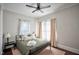 Bright bedroom with a ceiling fan, neutral walls, and natural light from the window at 508 S Swain St, Raleigh, NC 27601