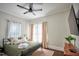 Cozy bedroom with a ceiling fan, hardwood floors and natural light from the window at 508 S Swain St, Raleigh, NC 27601