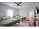 Comfortable bedroom featuring two twin beds, ceiling fan, and hardwood floors at 508 S Swain St, Raleigh, NC 27601