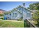 Rear exterior view of a house with green grass, garbage bins and fenced yard at 508 S Swain St, Raleigh, NC 27601