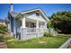 Gray two-story home featuring a welcoming front porch with white railings and brick facade at 508 S Swain St, Raleigh, NC 27601