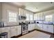 Modern kitchen featuring white cabinets, stainless steel appliances, and dark countertops at 508 S Swain St, Raleigh, NC 27601