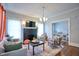 Open-concept living room with hardwood floors, decorative fireplace, and view into dining area at 508 S Swain St, Raleigh, NC 27601