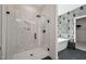 Modern bathroom with a glass walk-in shower and decorative wallpaper at 556 Contempo Dr # 22, Rolesville, NC 27571