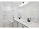 Well-lit bathroom featuring double sink vanity, tile flooring, and a shower-tub combo at 556 Contempo Dr # 22, Rolesville, NC 27571