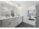 Stylish bathroom with a double vanity, matte black fixtures, and views to the bedroom at 556 Contempo Dr # 22, Rolesville, NC 27571