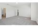 Spacious bedroom featuring neutral carpet, white walls, and entry to a modern ensuite bathroom at 556 Contempo Dr # 22, Rolesville, NC 27571