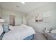 Bright bedroom with a comfy chair and a view into the hallway at 556 Contempo Dr # 22, Rolesville, NC 27571
