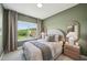 This bedroom has neutral walls, a plush bed, and backyard views at 556 Contempo Dr # 22, Rolesville, NC 27571