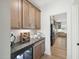 Butler's pantry with stylish wood cabinets, wine rack, and beverage fridge at 556 Contempo Dr # 22, Rolesville, NC 27571