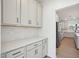 Butler's pantry with white cabinets, countertop and subway tile backsplash at 556 Contempo Dr # 22, Rolesville, NC 27571