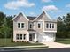 Two-story home with gray siding, brick accents, attached two-car garage and well-manicured lawn at 556 Contempo Dr # 22, Rolesville, NC 27571