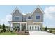 Charming two-story home with gray siding, brick accents, and a welcoming front porch at 556 Contempo Dr # 22, Rolesville, NC 27571