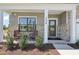 Inviting front porch with chairs, brick accents, and a view of the landscaped front yard at 556 Contempo Dr # 22, Rolesville, NC 27571