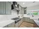 Beautiful kitchen features stainless steel appliances, gray cabinets, and bright countertops at 556 Contempo Dr # 22, Rolesville, NC 27571