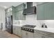 The kitchen features a stainless steel refrigerator and gas range with gray cabinets at 556 Contempo Dr # 22, Rolesville, NC 27571