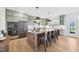 Modern kitchen featuring a large island, stainless steel appliances, stylish cabinets, and pendant lights at 556 Contempo Dr # 22, Rolesville, NC 27571