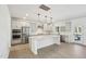 Open kitchen featuring a center island, stainless steel appliances, white cabinets, and hardwood floors at 556 Contempo Dr # 22, Rolesville, NC 27571