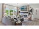 The open concept living room features a fireplace, mounted tv, and backyard views at 556 Contempo Dr # 22, Rolesville, NC 27571