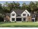 Stunning exterior elevation view of modern home with stone accents, large windows, and professionally landscaped yard at 5808 Norwood Ridge Dr, Raleigh, NC 27614
