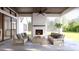 Covered outdoor patio featuring a cozy fireplace, comfortable seating, and scenic views at 5808 Norwood Ridge Dr, Raleigh, NC 27614