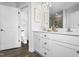 Bathroom features a double vanity, framed mirrors, white cabinets, and framed art at 6401 Granite Quarry Dr, Raleigh, NC 27610