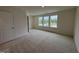 Bright bedroom offers natural light with neutral walls and carpeted floors, creating a serene and inviting atmosphere at 6401 Granite Quarry Dr, Raleigh, NC 27610