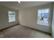 Bright bedroom features cozy carpeting and dual windows that flood the space with natural light, creating a welcoming ambiance at 6401 Granite Quarry Dr, Raleigh, NC 27610