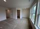 Spacious bedroom with plush carpet and two large windows offers ample natural light and a serene atmosphere at 6401 Granite Quarry Dr, Raleigh, NC 27610