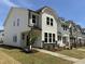 Row of new construction two-story homes with manicured lawns and welcoming curb appeal on a sunny day at 6401 Granite Quarry Dr, Raleigh, NC 27610