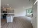 Bright kitchen with gray cabinets, granite countertops, and stainless steel appliances, with ample space and natural light at 6401 Granite Quarry Dr, Raleigh, NC 27610