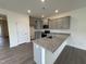 Stylish kitchen features granite counters, gray cabinets, recessed lighting, and stainless steel appliances for a modern appeal at 6401 Granite Quarry Dr, Raleigh, NC 27610