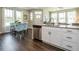 Kitchen featuring wood floors, stainless appliances, white cabinets, granite countertops, and a dining area at 6401 Granite Quarry Dr, Raleigh, NC 27610