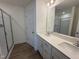 Modern bathroom featuring a double vanity, quartz countertop and glass-enclosed shower at 6403 Granite Quarry Dr, Raleigh, NC 27610