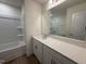 Well-lit bathroom with white cabinetry, quartz countertops, and modern fixtures at 6403 Granite Quarry Dr, Raleigh, NC 27610
