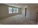 Large primary bedroom featuring soft carpet, light-colored walls, and ample natural light at 6403 Granite Quarry Dr, Raleigh, NC 27610